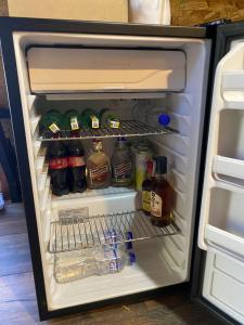 an open refrigerator filled with lots of drinks at ALTEA triángulo con jacuzzi, Santa Elena in Medellín