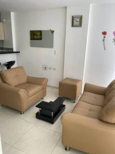 a living room with two couches and a table at La Morada del Sur in Floridablanca