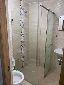 a bathroom with a shower with a toilet and a sink at La Morada del Sur in Floridablanca