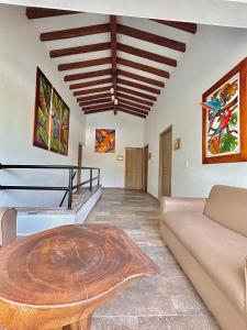 a living room with a table and a couch at Finca Hotel California Doradal in Doradal