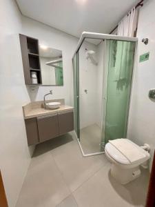 a bathroom with a shower and a toilet and a sink at Pousada Hoffmann in Florianópolis
