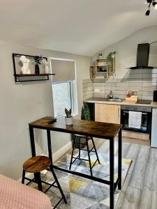 a kitchen with a table and two chairs in a room at DVM escape Flat 2 in Bristol
