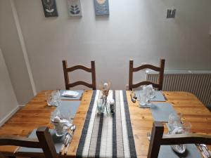 a wooden table with glasses on top of it at The Granary House - Luxury Stays in Plymouth