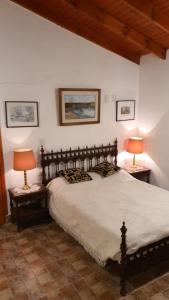a bedroom with a large bed with two lamps on tables at Casa Quinta La Gualeya in Gualeguay +69 photos