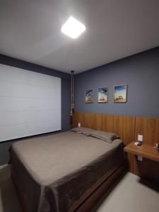 a bedroom with a large bed and a white screen at Paraíso Guarajuba in Guarajuba +20 photos