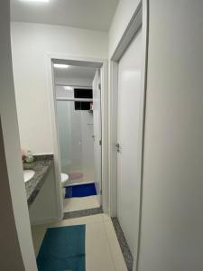 y baño con ducha a ras de suelo y lavamanos. en Apartamento em Guarajuba - Condomínio Paraíso dos Coqueiro en Guarajuba