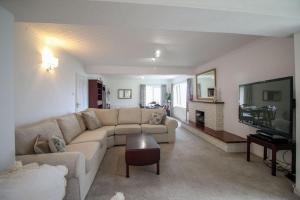 a living room with a couch and a tv at Clifton Villa in Newquay