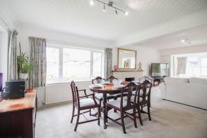 a living room with a dining room table and chairs at Clifton Villa in Newquay