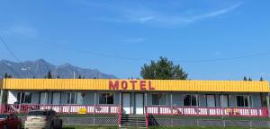 a motel with a car parked in front of it at Glacier View Inn in Haines Junction
