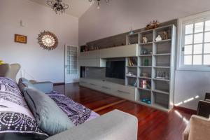 Casa confortável e aconchegante في بينتو جونكالفيس: غرفة معيشة بها أريكة وتلفزيون