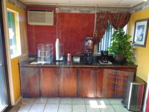 a kitchen with a wooden counter in a room at Economy Inn Express Warren in Warren