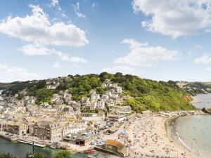 a town on a hill with a beach at The Dawn in Looe