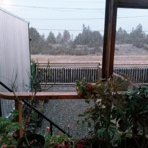 a view from a window of a porch with a fence at MiDpto2 in San Carlos de Bariloche
