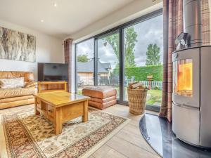 a living room with a couch and a table at The Hideaway in Chapel Saint Leonards