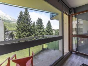 a room with a large window with a view of trees at Studio lumineux pour 3 personnes près des pistes, cheminée électrique - FR-1-400-118 in Eaux-Bonnes