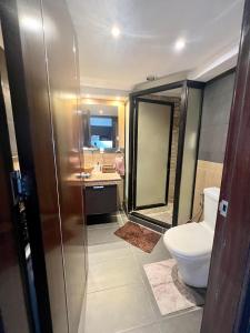 a bathroom with a toilet and a shower and a sink at Super Cebu Loft in Cebu City