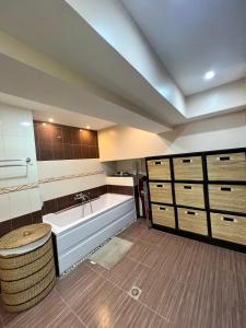 a bathroom with a bath tub and a sink at Super Cebu Loft in Cebu City