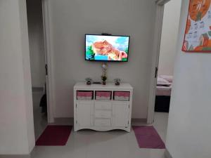 a white cabinet with a tv on a wall at Latasari 33A Homestay in Tuban