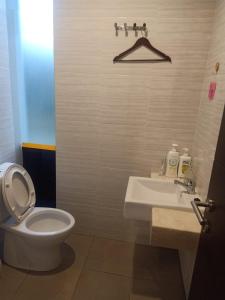 a bathroom with a toilet and a sink at Villa Canyata in Pasuruan