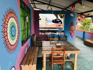 a table and chairs in a restaurant with a colorful wall at Zumag Sisa in Tena