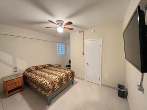 a bedroom with a bed and a ceiling fan at HOTEL VILLAGRAN in Tijuana