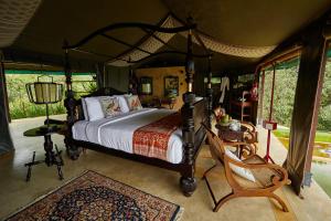 a bedroom with a bed in a tent at Madulkelle Tea and Eco Lodge in Kandy