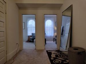 a hallway with a mirror and a living room at Gorgeous ,stylish and Beautiful Luxury Apartment with stuning Downtown View.Featuring American and French style in Frederick
