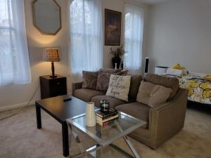 a living room with a couch and a coffee table at Gorgeous ,stylish and Beautiful Luxury Apartment with stuning Downtown View.Featuring American and French style in Frederick