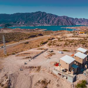 an aerial view of a building in the middle of a mountain at Reflejo del Lago - Cabañas frente al Dique Potrerillos in Ciudad Lujan de Cuyo