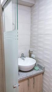 uma casa de banho com um lavatório e uma cabina de duche em vidro. em la casa hermosa em Quito