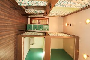 a small room with a green floor and a ceiling at Lost & Found Zanzibar in Zanzibar City