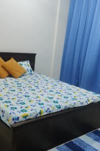 a bed in a room with a blue curtain at SERENITY - Apartment with Modern Amenities in Igatpuri +32 photos