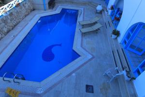 an overhead view of a large blue swimming pool at Bellapais Abbey Boutique Hotel in Kyrenia