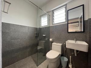 a bathroom with a toilet and a sink and a shower at Ninety Guest House in Ipoh
