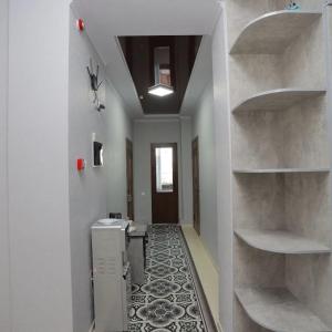 a hallway with a room with a sink and shelves at АУРУМ ОТЕЛЬ КЫЗЫЛ-КИЯ 