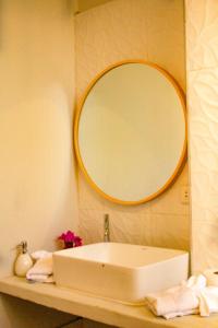 a bathroom with a sink and a large mirror at Panorama garden inn in Máncora