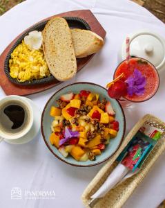 a table with a bowl of food and a plate of food at Panorama garden inn in Máncora