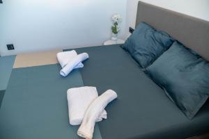 a bed with two towels and two pillows on it at Aegean Stars in Rhodes Town +93 photos