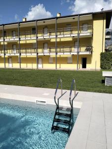 a swimming pool in front of a building at L&G APARTAMENT in Nago-Torbole