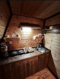 a small kitchen with a sink in a cabin at A frame for families in Quba