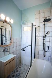 y baño con ducha, lavabo y espejo. en Beautiful 1BR Central TLV Flat, en Tel Aviv