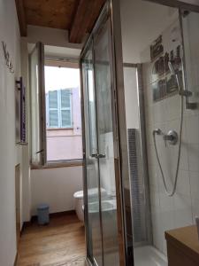 a bathroom with a shower and a toilet at La Finestra sul Porto Apartment in Ancona