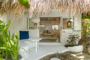 a room with a bed and a couch and a table at Gravity Eco Boutique Hotel - Adults Only in Uluwatu