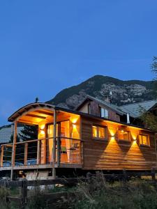 a large wooden house with a mountain in the background at Alpine love shack in Villar-Saint-Pancrace