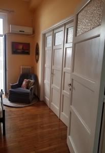 a living room with a door and a chair at Angels sleep here in Athens