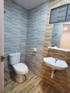 a bathroom with a toilet and a sink at Numhom Resort in Ban Nong Chum Saeng +119 photos