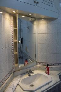 a bathroom with a sink and a mirror at Giza - Pyramids/Museum Apartment in Cairo +30 photos