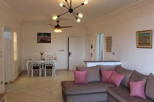 a living room with a couch and a table at Giza - Pyramids/Museum Apartment in Cairo