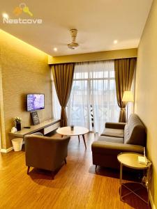 a living room with a couch and a table at Costa Mahkota Suites Malacca Central By Nestcove in Melaka