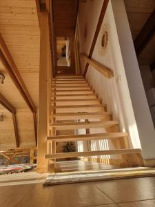 a staircase in a house with wooden ceilings at Casuta Armonia in Moisei